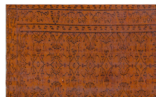 Load image 1 in gallery view. Rust-colored rug with a dark brown geometric diamond pattern and a decorative border.