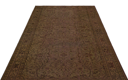 Load image 1 in gallery view. Dark brown traditional rug with a distressed floral medallion pattern and a geometric border.