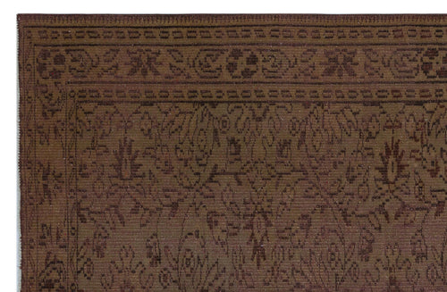 Load image 1 in gallery view. Dark brown traditional rug with a tonal floral pattern and a geometric border.