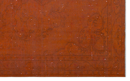 Load image 1 in gallery view. Burnt orange rug with a subtle, tonal distressed floral pattern and a bordered edge.