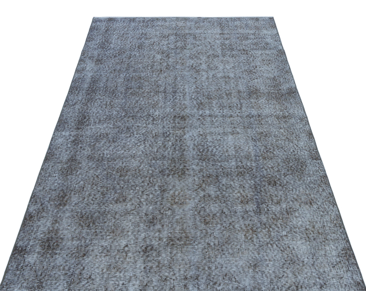 Grey and charcoal distressed area rug with a faded, vintage-inspired texture on a white background.