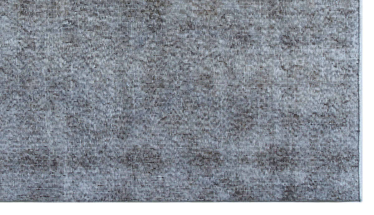 Charcoal and light gray distressed rug with a faded, textured abstract pattern.