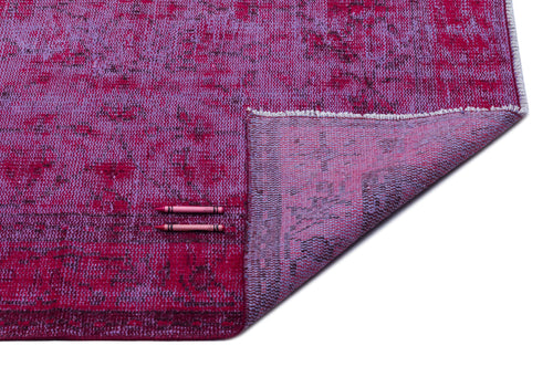 Load image 1 in gallery view. Magenta and violet distressed-pattern rug with a folded corner revealing the woven backing, on a white background.