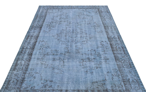 Load image 1 in gallery view. Light blue distressed rug with a dark grey traditional floral medallion and border pattern on a white background.