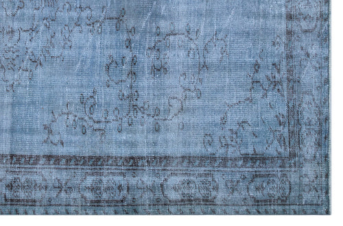 Load image 1 in gallery view. Distressed blue rug with a faded charcoal floral medallion pattern and a dark geometric border.