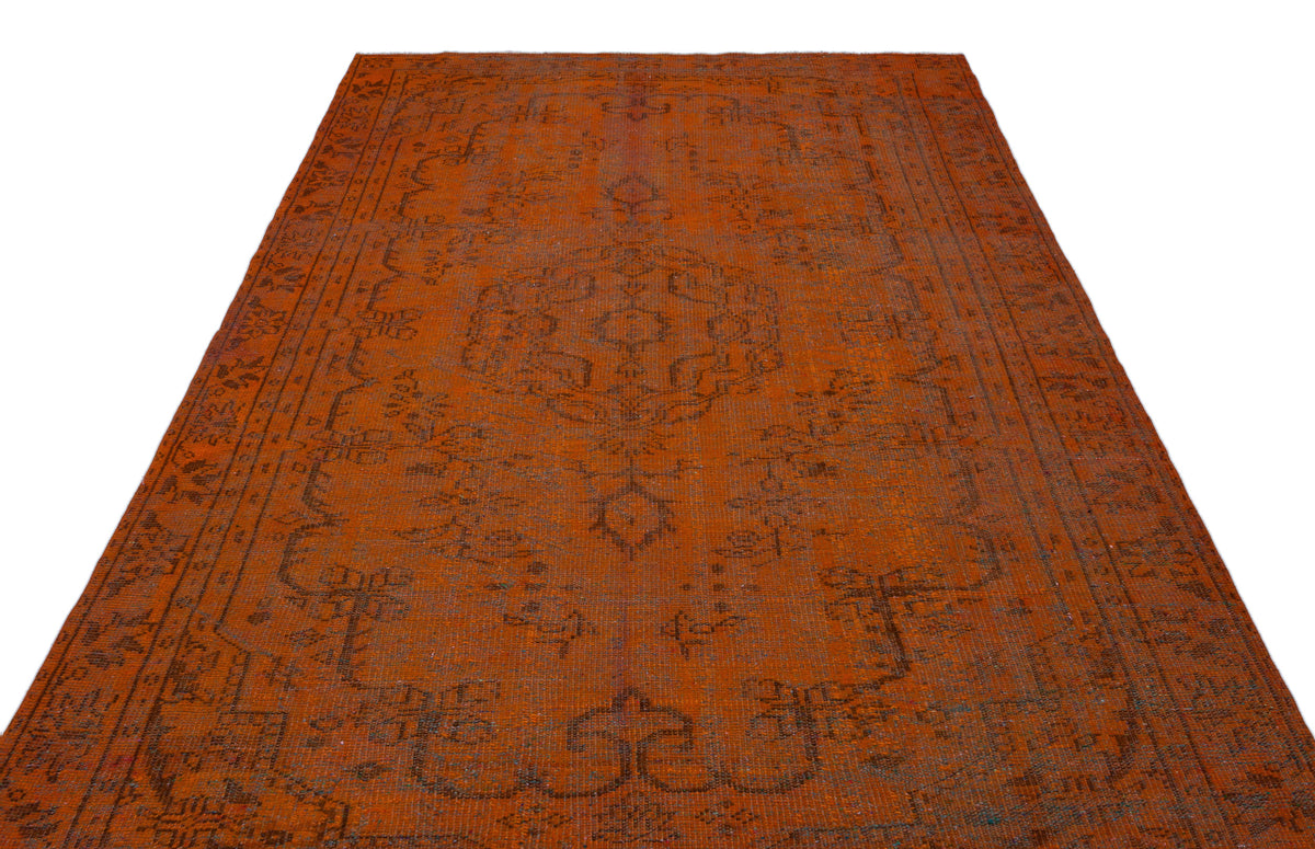 Burnt orange vintage-style rug with a dark charcoal traditional medallion and border pattern on a white background.