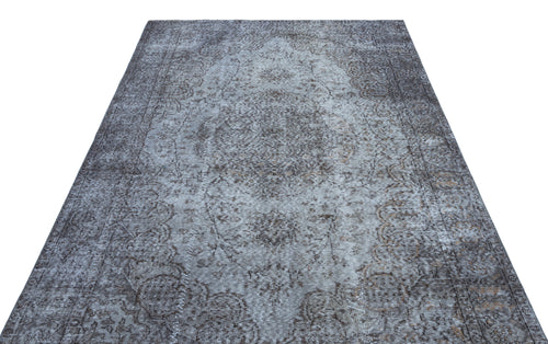Load image 1 in gallery view. Grey and charcoal distressed traditional rug with a central medallion and ornate floral border on a white background.