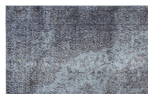 Load image 1 in gallery view. Grey and charcoal distressed rug with a faded traditional floral medallion pattern.