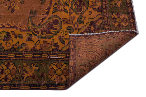 Load image 1 in gallery view. Rust, olive, and dark brown traditional patterned rug with a folded corner revealing the textured underside.