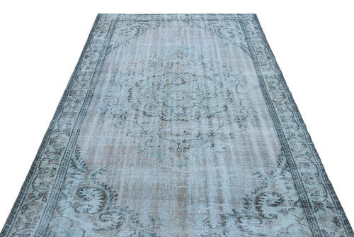 Load image 1 in gallery view. Light blue and grey distressed vintage-style rug with a central floral medallion and ornate border.