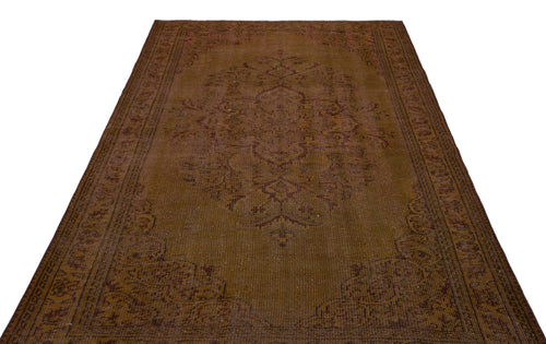 Load image 1 in gallery view. Distressed brown traditional rug with a central floral medallion and ornate border on a white background.
