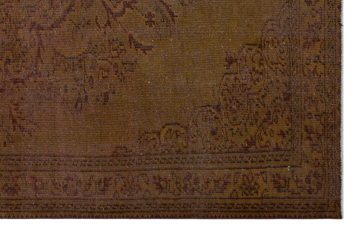 Brown traditional rug with a faded, distressed medallion pattern and a detailed border on a white background.
