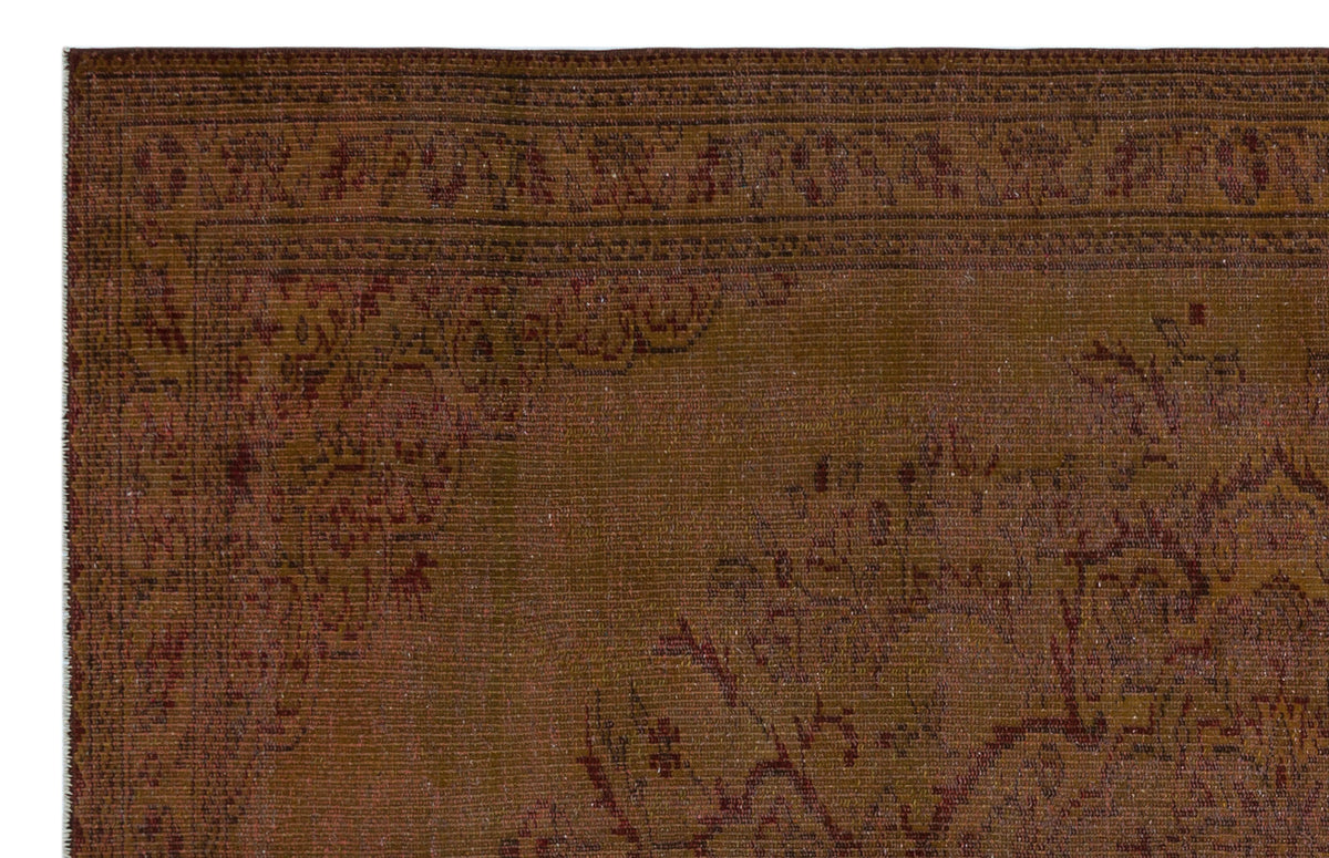 Dark brown traditional rug with a subtle, tonal floral medallion pattern and a detailed border.