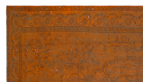 Load image 1 in gallery view. Burnt orange vintage-style rug with a faded, dark brown floral border and central medallion pattern.
