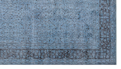 Load image 1 in gallery view. Blue and charcoal distressed traditional rug with a faded floral medallion pattern and a wide decorative border.