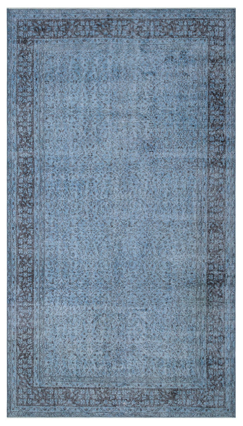 Load image 1 in gallery view. Blue and charcoal distressed rug with a traditional ornate border and a subtle, faded floral center pattern.