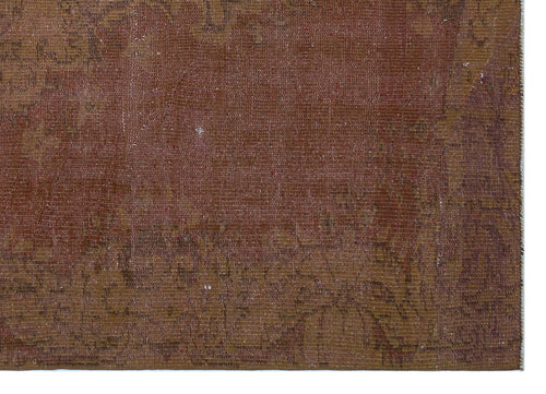 Load image 1 in gallery view. Distressed terracotta and brown vintage-style rug with a faded, intricate traditional pattern.