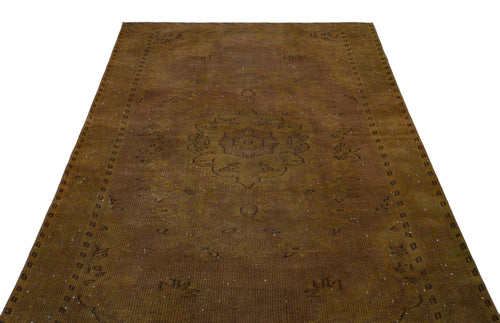 Load image 1 in gallery view. Distressed brown vintage-style rug with a central medallion and geometric border pattern on a white background.