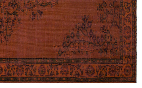 Load image 1 in gallery view. Rust-colored rug with a dark brown floral vine pattern and a geometric border.