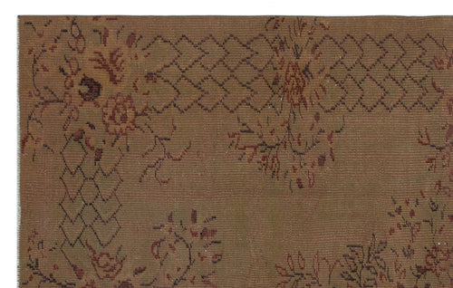 Load image 1 in gallery view. Brown vintage-style rug with a dark red floral motif and a geometric diamond border pattern.