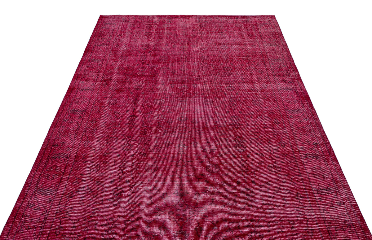 Deep magenta vintage-style rug with a distressed, faded traditional medallion pattern on a white background.