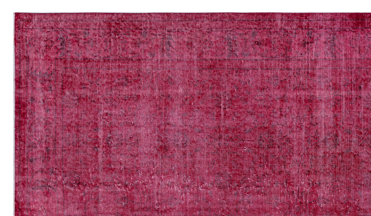 Deep magenta distressed rug with a subtle, faded traditional pattern and a dark border.