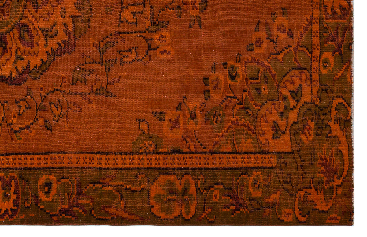 Rust orange and dark brown traditional rug with a detailed floral medallion pattern and a decorative border.