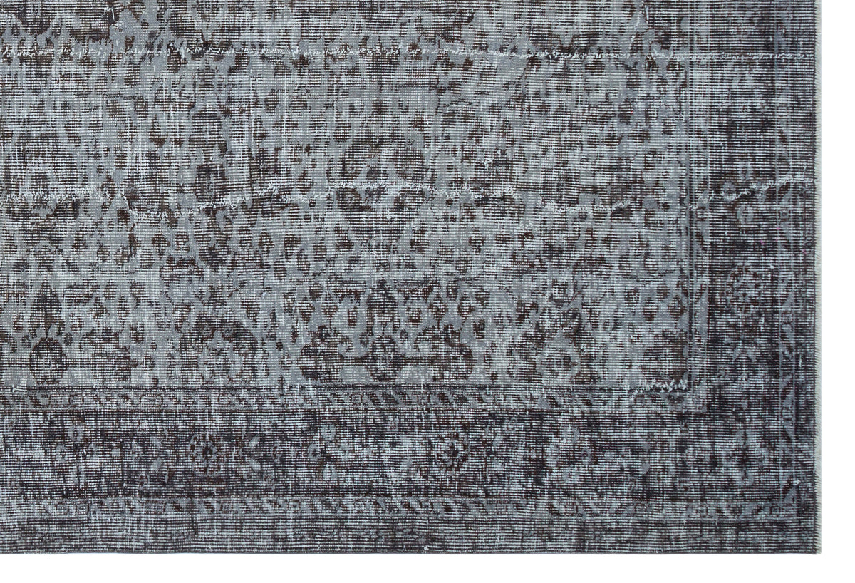 Charcoal and slate grey rug with a distressed, traditional medallion pattern and a detailed border.