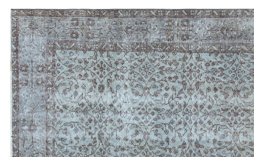 Load image 1 in gallery view. Distressed light blue and brown rug with a traditional floral medallion pattern and a geometric border.