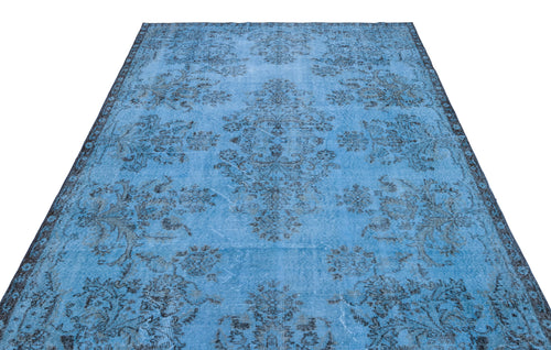 Load image 1 in gallery view. Bright blue distressed rug with a dark charcoal floral medallion pattern on a white background.