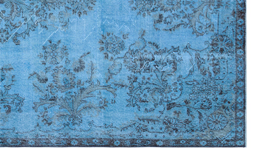 Load image 1 in gallery view. Bright blue rug with a distressed black floral pattern and a dark decorative border.