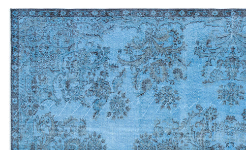 Load image 1 in gallery view. Bright blue rug with a distressed black floral medallion pattern and a decorative border.