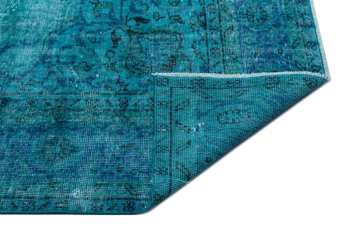 Load image 1 in gallery view. Teal and blue distressed traditional rug with a faded medallion pattern, shown with a corner folded over.
