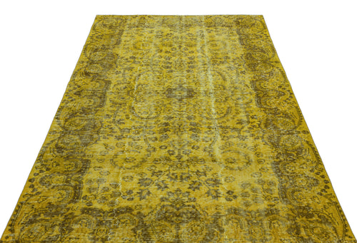 Load image 1 in gallery view. Mustard yellow and brown distressed vintage-style rug with a traditional floral medallion pattern.