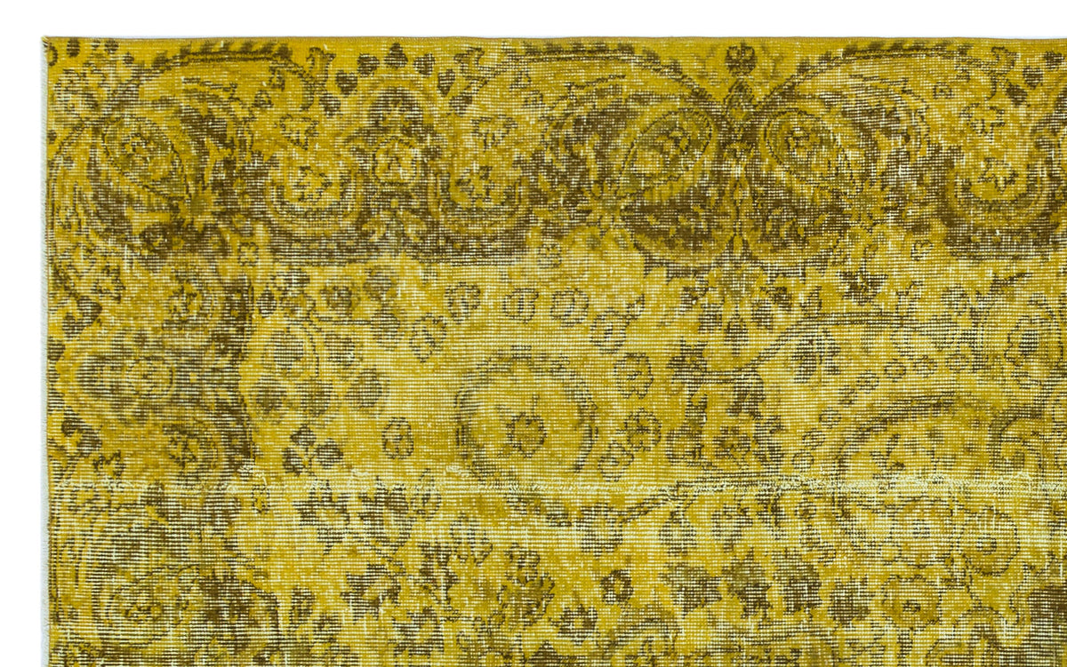 Mustard yellow and olive green vintage-style rug with a distressed traditional floral medallion pattern.