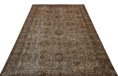 Load image 1 in gallery view. Brown and beige vintage-style rug with a distressed traditional floral medallion pattern on a white background.