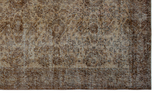 Load image 1 in gallery view. Brown and beige distressed rug with a faded traditional medallion pattern and a solid border.