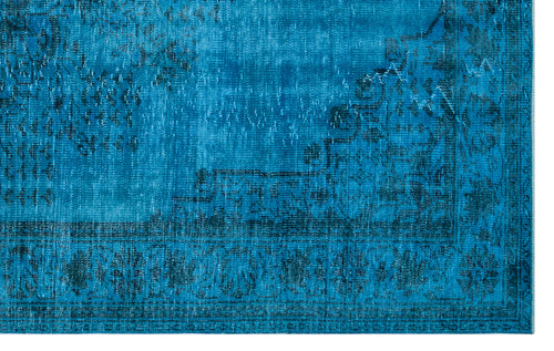Load image 1 in gallery view. Bright blue distressed rug with a dark navy traditional floral medallion pattern and a detailed border.