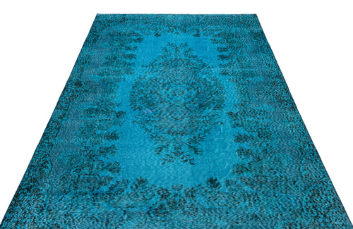Load image 1 in gallery view. Bright turquoise area rug with a distressed black floral medallion pattern on a white background.
