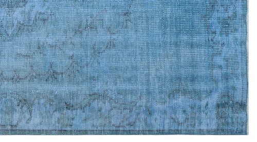 Load image 1 in gallery view. Bright blue distressed rug with a faded, traditional overdyed pattern on a white background.