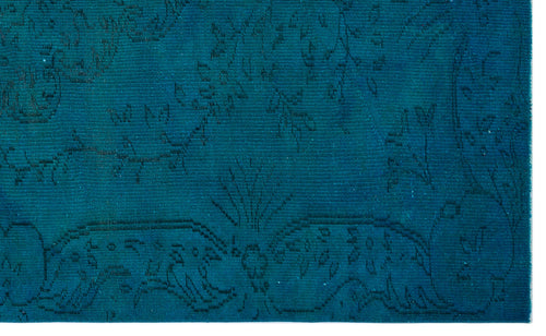 Load image 1 in gallery view. Teal rug with a subtle, dark-toned floral and vine pattern in a flat-weave texture.