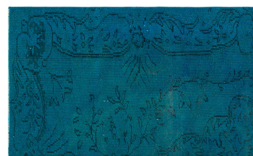 Load image 1 in gallery view. Teal rug with a subtle, dark-toned floral and vine pattern on a white background.