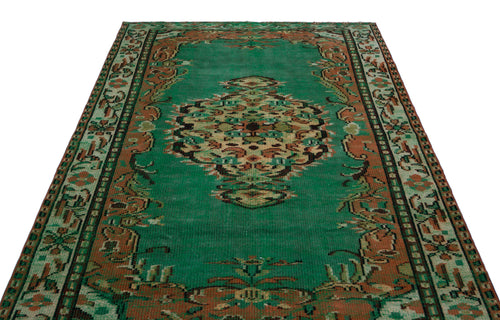 Load image 1 in gallery view. Emerald green vintage rug with a central medallion and ornate border in rust, brown, and cream tones.