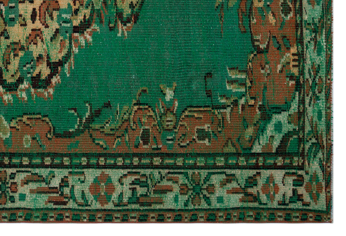 Emerald green vintage rug with a distressed brown and beige traditional border pattern on a white background.
