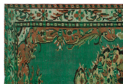 Load image 1 in gallery view. Green and rust-colored traditional rug with a distressed floral border and central medallion pattern.