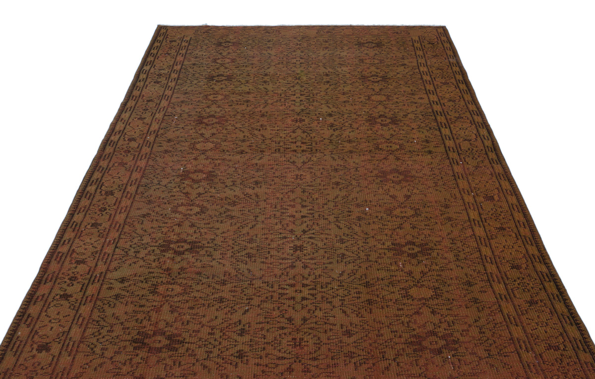 Rust and brown vintage-style rug with an intricate all-over floral medallion pattern and a geometric border.