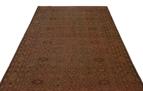 Load image 1 in gallery view. Rust and brown vintage-style rug with an intricate all-over floral medallion pattern and a geometric border.