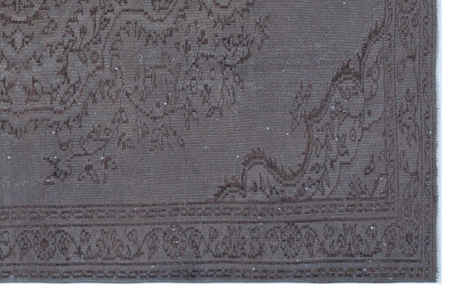 Load image 1 in gallery view. Dark charcoal grey rug with a faded, traditional floral medallion pattern and a geometric border.