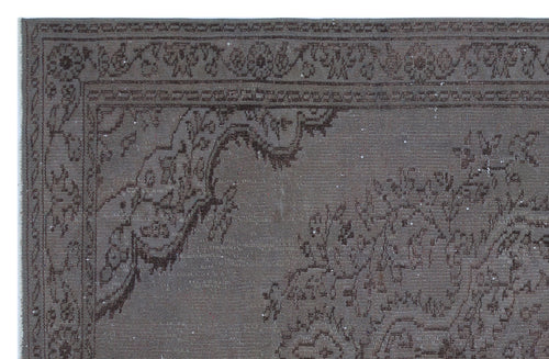 Load image 1 in gallery view. Dark brown distressed rug with a traditional floral medallion border and intricate ornamental patterns.
