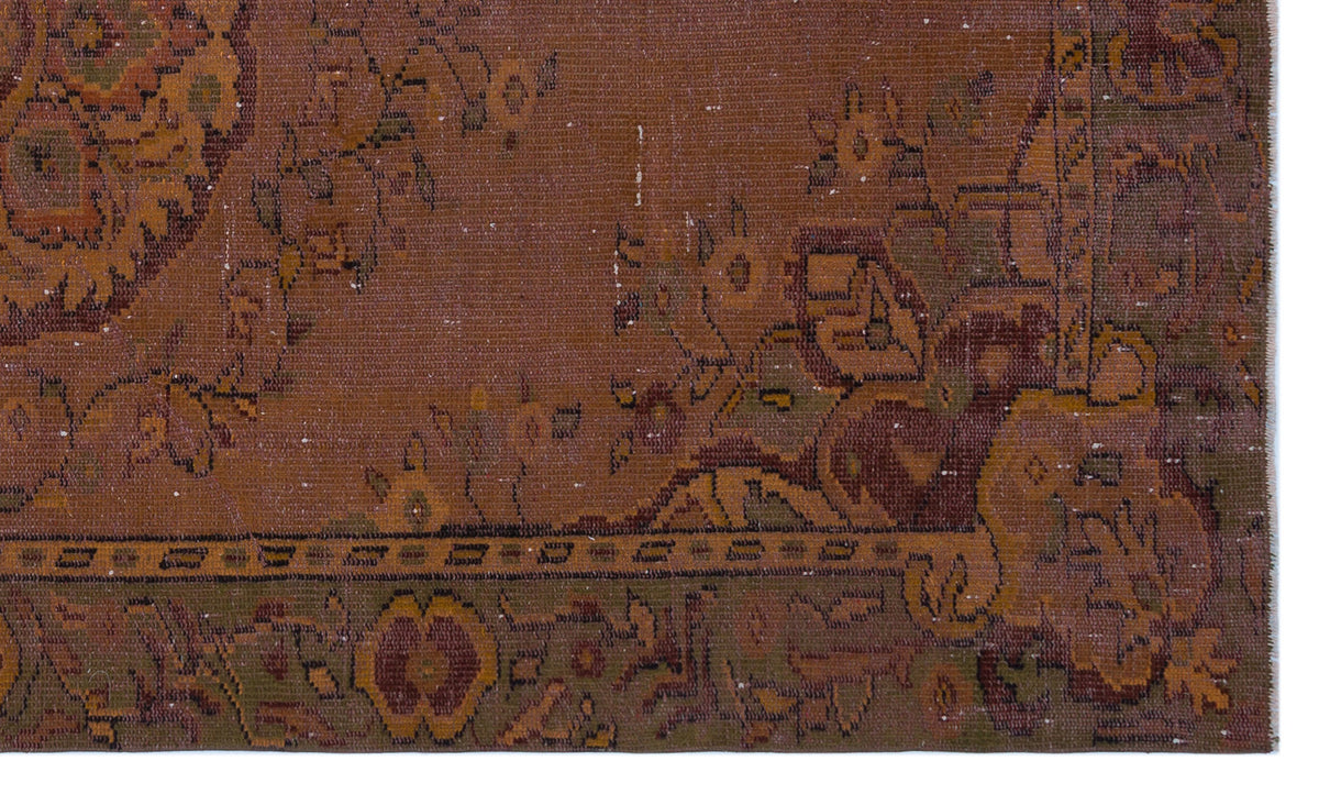 Distressed rust-brown rug with a faded traditional floral medallion pattern and a dark olive green border.